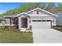 Charming single-Gathering home featuring a two-car garage and appealing curb appeal with a landscaped front yard at 4235 Sawtooth Ct, Tavares, FL 32778