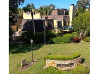 Bay Hill Condominiums exterior view showing tropical landscaping and well-maintained grounds at 6258 Masters Blvd # C204, Orlando, FL 32819