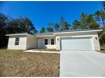 New construction home with attached garage and driveway at 6809 149Th Lane Rd, Ocala, FL 34473