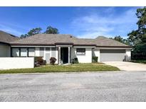 Charming single-story home with an attached garage and well-maintained landscaping in a neighborhood setting at 1493 Magellan Cir # 504, Orlando, FL 32818