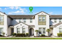 Charming townhome featuring neutral colors, well-maintained landscaping, and inviting front entrance at 434 Captiva Dr, Davenport, FL 33896