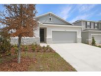 Charming home featuring stone accents, manicured landscaping, and a two-car garage at 1753 Carnelian St, Deland, FL 32720