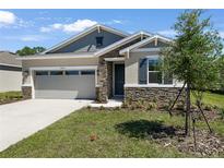 Charming single-Gathering home with stone accents, well-kept landscaping, and a two-car garage at 4064 Bannock Ave, Tavares, FL 32778