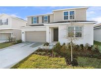 Charming two-story home with a well-maintained lawn and neutral color scheme at 5418 Catmint Dr, Lake Hamilton, FL 33851