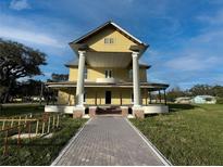 Grand two-story home featuring a large wrap-around porch and stately columns at 701 1St Ne St, Fort Meade, FL 33841