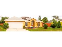 Charming single-story home with well-maintained landscaping and solar panels, enhancing curb appeal at 1053 Hemingway Dr, Deltona, FL 32725