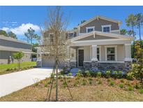 Charming two-story home featuring stone accents, manicured landscaping, and a well-maintained front yard on a sunny day at 3716 Deer Ridge Dr, Mount Dora, FL 32757