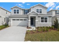Charming two-story home with a two-car garage and well-maintained landscaping at 1455 August Gray Dr, Kissimmee, FL 34744