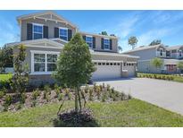 Beautiful two-story home featuring stone accents, a three-car garage and landscaped front yard at 3724 Deer Ridge Dr, Mount Dora, FL 32757
