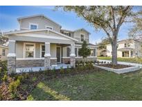 Charming two-story home featuring stone accents, a covered porch, and beautifully landscaped front yard at 3824 Deer Ridge Dr, Mount Dora, FL 32757