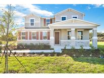 Two-story house with stone accents and red shutters at 520 Summit River Dr, Apopka, FL 32712