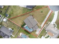 Aerial view showcasing the home's layout, pool, and surrounding property lines in a cul-de-sac at 1855 Cavalier Ct, Kissimmee, FL 34744