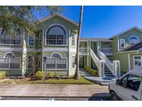 Inviting multi-story exterior with neat landscaping, white trim, and a wheelchair access sign at 3151 Britannia Blvd # C, Kissimmee, FL 34747