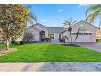 Single-story house with a two-car garage and lush lawn at 3634 Northwoods Dr, Kissimmee, FL 34746