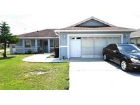 Charming single-story home featuring a covered front porch and an attached two-car garage at 101 Whitehall Way, Kissimmee, FL 34758
