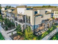 Modern townhome with stucco and stone accents, private balconies, and well-maintained landscaping at 1800 Houston St, Kissimmee, FL 34743