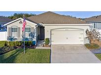 Single-story home with a two-car garage and well-maintained lawn at 1869 Brockridge Rd, Kissimmee, FL 34744