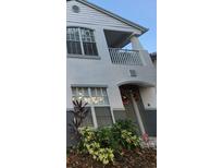 Two-story house exterior with festive wreath, landscaping, and balcony at 4320 S Kirkman Rd # 1513, Orlando, FL 32811
