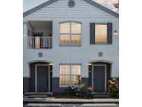 Charming two-story condo with a balcony, large windows, and well-manicured landscaping at 4368 S Kirkman Rd # 201, Orlando, FL 32811