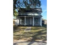Charming home featuring a covered front porch and well-maintained lawn at 1700 Kentucky Ave, St Cloud, FL 34769