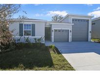 Two-story house with attached garage and landscaping at 1744 Carnelian St, Deland, FL 32720