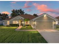 House exterior at dusk showcasing landscaping and driveway at 545 Pintail Cir, Auburndale, FL 33823