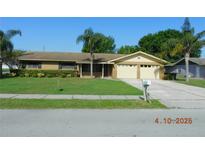 Charming single-story home with a well-manicured lawn and mature palm trees at 436 Michigan Ave, St Cloud, FL 34769