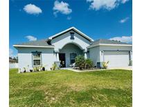 Single-story home with a two-car garage and landscaped lawn at 932 Albertville Ct, Kissimmee, FL 34759