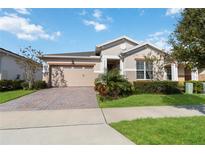 Single-story home with a two-car garage and landscaped yard at 2756 Greenlands St, Saint Cloud, FL 34772