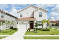 Two-story house with a two-car garage, and a well-maintained lawn at 2950 Buccaneer Palm Rd, Kissimmee, FL 34747