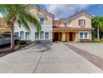 Two-story townhome with Spanish-style tile roof and parking at 4723 Terrasonesta Dr, Davenport, FL 33837