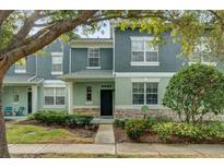 Two-story townhome with neutral siding, landscaping, and walkway at 4731 Capital Blvd, Saint Cloud, FL 34769