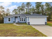 Newly built home with a two-car garage and landscaped yard at 832 Marion Oaks Mnr, Ocala, FL 34473