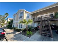 Exterior view of condo building with parking and landscaping at 2332 Prime Cir # B, Kissimmee, FL 34746