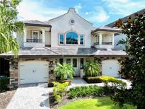 Charming two-story home featuring a well-manicured front yard and a two-car garage at 8162 Valhalla Ter, Reunion, FL 34747
