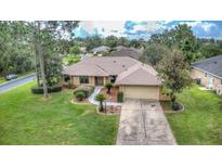 Single-story home with a two-car garage and spacious yard at 26 Lake Diamond Ave, Ocala, FL 34472