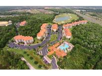 Aerial view of community with resort-style pool, golf course, and multiple buildings at 1361 Tuscan Ter # 7305, Davenport, FL 33896