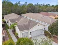 Attractive single-story home with a two-car garage and landscaped yard at 1813 Pelican Hill Way, Poinciana, FL 34759