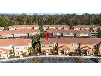 Aerial view of townhouses with a focus on one unit at 2621 Bugatti Ct, Kissimmee, FL 34746