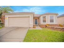 Single-story home with a two-car garage and landscaped lawn at 3643 Julius Estates Blvd, Winter Haven, FL 33881