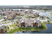 Aerial view of apartment community by lake with green space at 4105 Tropical Isle Blvd # 216, Kissimmee, FL 34741