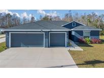 House exterior showcasing a two-car garage and well-manicured lawn at 534 Bristol Cir, Kissimmee, FL 34758