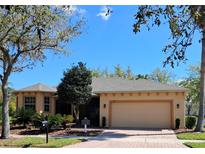 Charming single-story home featuring a two-car garage and well-manicured landscaping and a brick paver driveway at 900 Shorehaven Drive, Poinciana, FL 34759