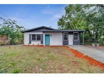 Newly renovated home with a teal door and modern exterior at 1414 Vonderay Rd, Orlando, FL 32825