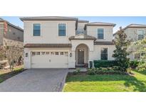 Two-story house with a three-car garage and landscaped lawn at 1455 Rolling Fairway Dr, Davenport, FL 33896