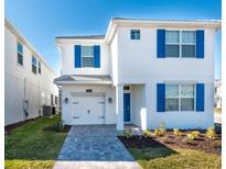Two-story house with blue shutters and a white exterior at 1560 Flange Dr, Davenport, FL 33896