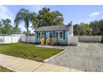Charming single-story home with a cozy front yard, stone pathway and lush landscaping at 1900 E Orange Ave, Eustis, FL 32726