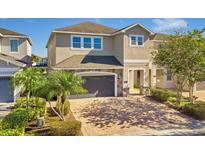 Two-story house with a gray garage door and brick facade at 7430 Marker Ave, Kissimmee, FL 34747