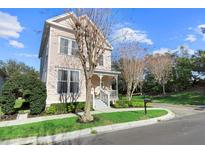 Charming two-story house with a front porch and well-manicured lawn at 121 Longview Ave, Celebration, FL 34747