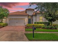 Beautiful home with a tile roof, a large garage, and a manicured lawn at 1395 Dolphin Head St, Davenport, FL 33896